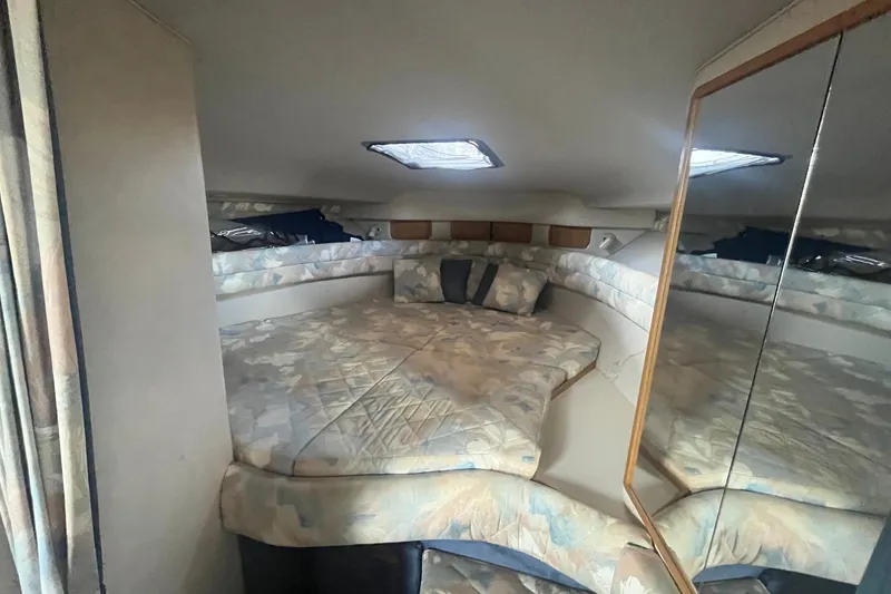 Slide: The Image of Interior cabin of 1993 Sea Ray Sundancer 330 with mirrored walls and cushioned seating. - 14