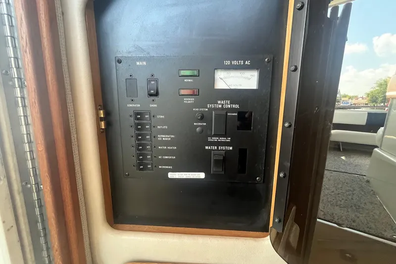 Slide: The Image of Control panel of a 1993 Sea Ray Sundancer 330 boat, featuring electrical and waste system controls. - 21