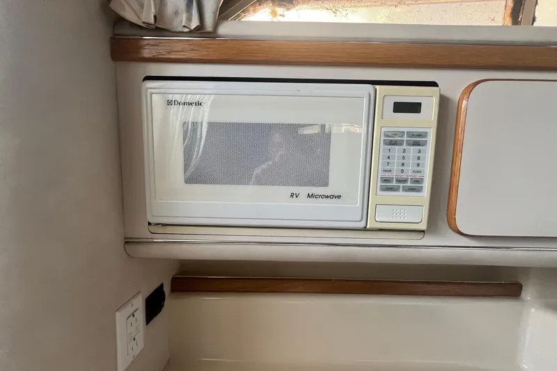Slide: The Image of Built-in Dometic RV microwave in 1993 Sea Ray Sundancer 330 yacht interior. - 18