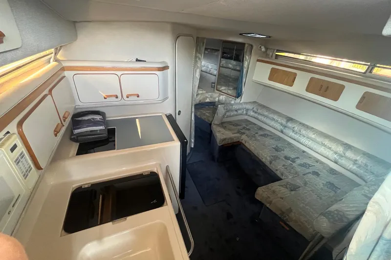 Slide: The Image of Interior of 1993 Sea Ray Sundancer 330 yacht with kitchenette and seating area. - 11