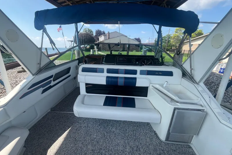Slide: The Image of 1993 Sea Ray Sundancer 330 boat interior with seating, steering wheel, and lake view. - 3