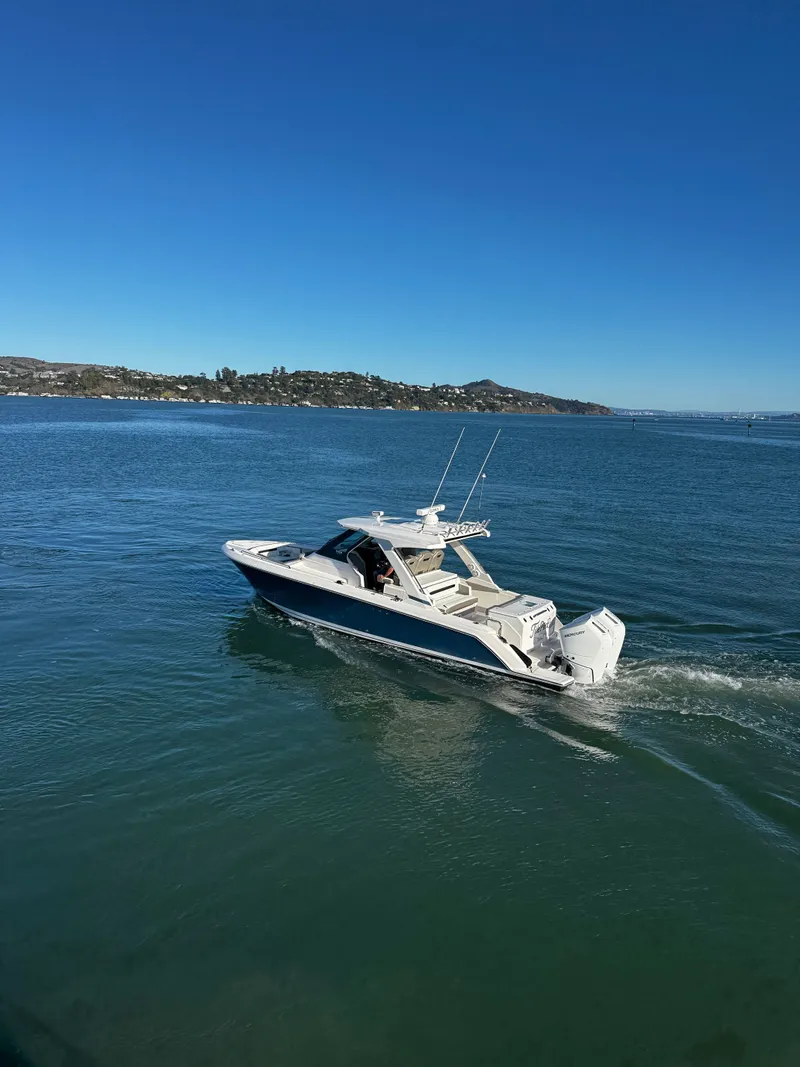 Slide: The Image of A sleek motorboat cruises on calm water under a clear sky. - 7
