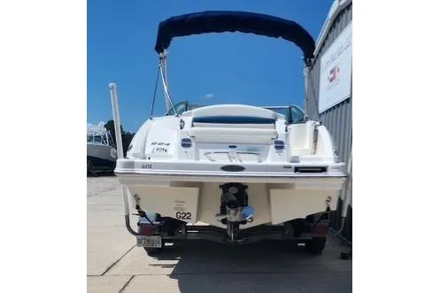 Slide: The Image of 2008 Chaparral Sunesta 224 boat with blue canopy, parked at a marina. - 5