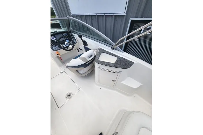 Slide: The Image of 2008 Chaparral Sunesta 224 boat interior with helm and seating area. - 3