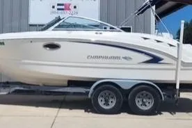 The Image of 2008 Chaparral Sunesta 224 boat on trailer, parked outside a building. - 1