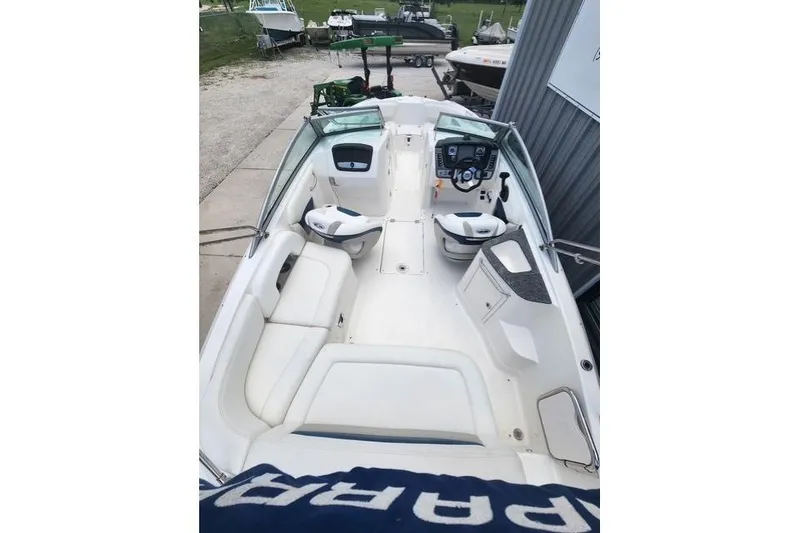Slide: The Image of 2008 Chaparral Sunesta 224 boat interior with seating and steering console. - 2