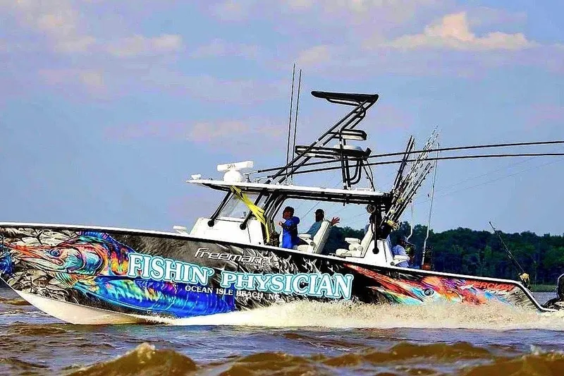 Slide: The Image of 2020 Freeman 42LR boat "Fishin' Physician" cruising on water, vibrant graphics. - 4