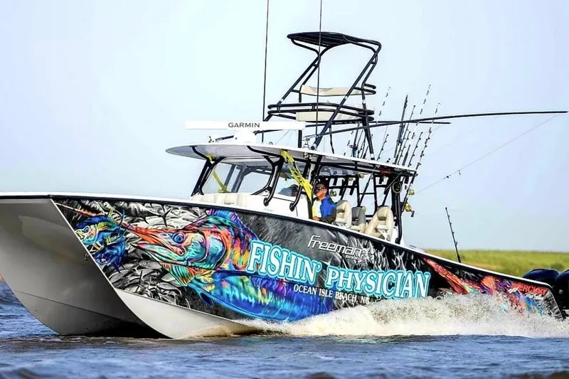 The Image of 2020 Freeman 42LR boat with vibrant fishing-themed graphics on the water. - 0