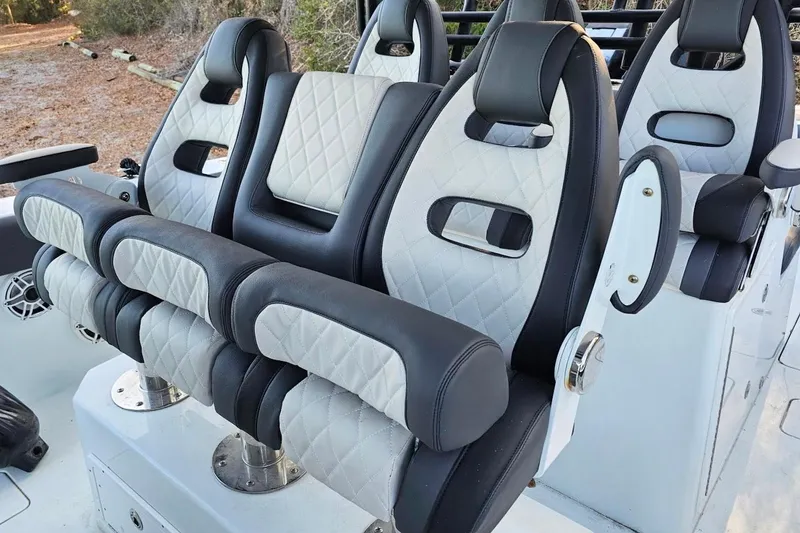 Slide: The Image of Luxury seating on a 2020 Freeman 42LR boat, featuring quilted upholstery and armrests. - 7
