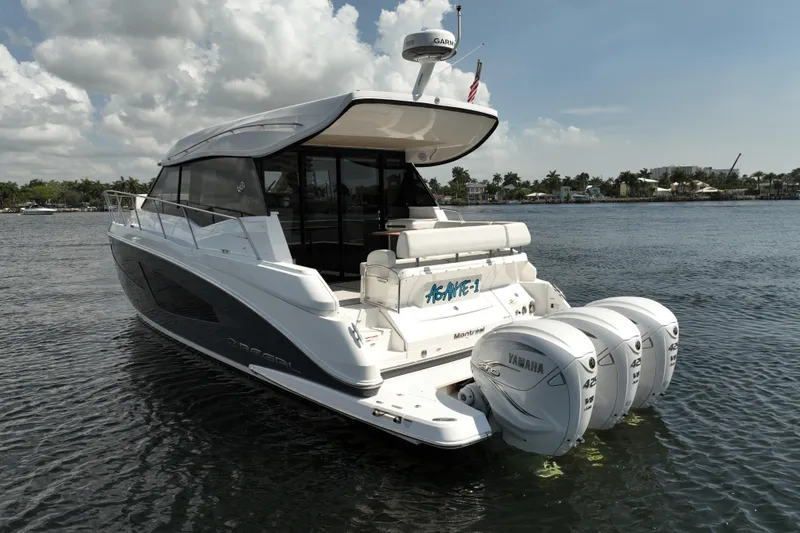 Slide: The Image of 2022 Regal 42 XO yacht with triple Yamaha engines on a sunny day. - 7