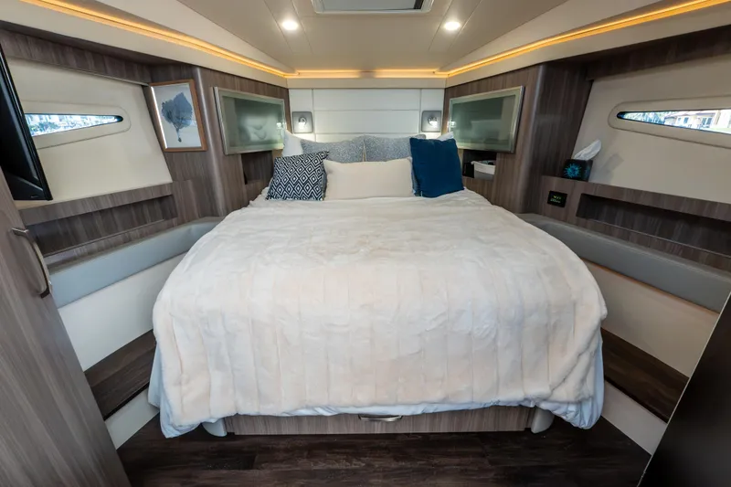 Slide: The Image of Luxurious cabin interior of 2022 Regal 42 XO yacht with cozy bedding and modern decor. - 46