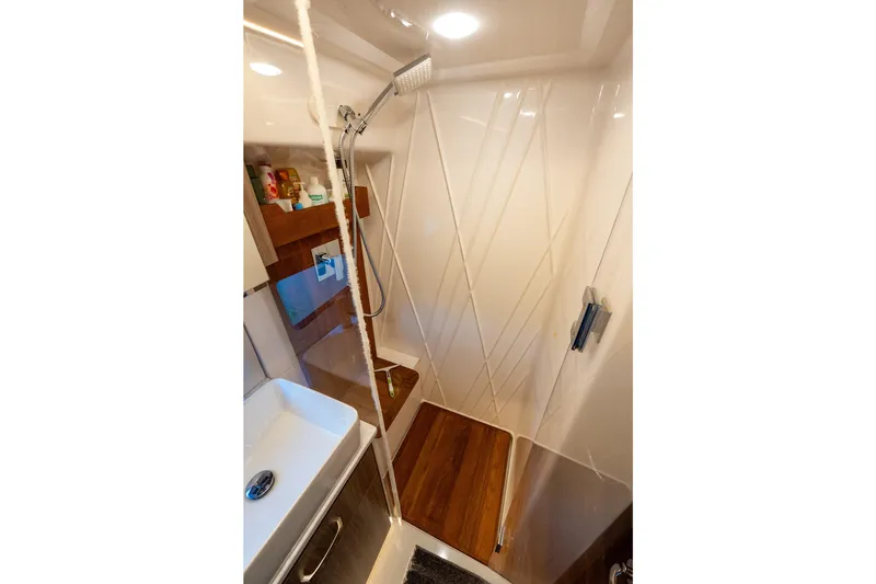 Slide: The Image of Modern shower area in 2022 Regal 42 XO yacht with sleek design and wooden accents. - 54