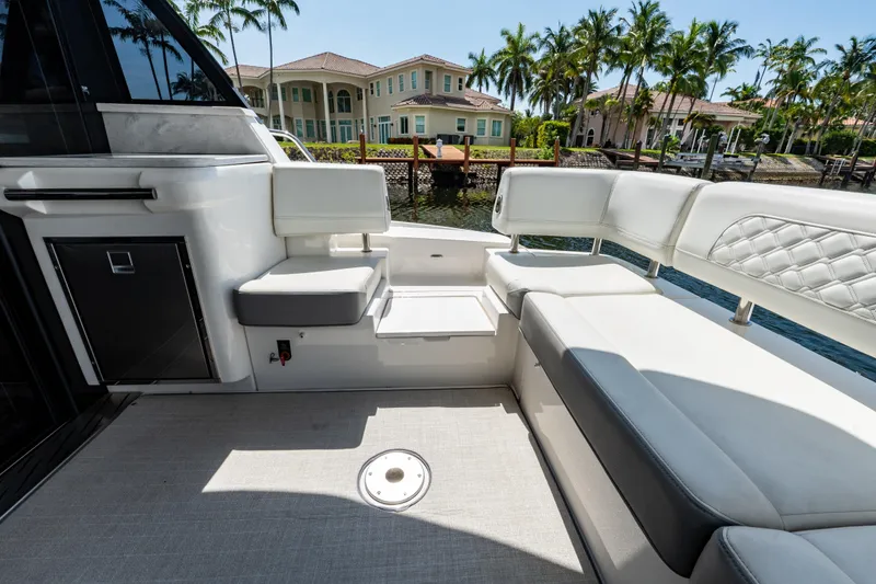 Slide: The Image of Luxurious seating area on a 2022 Regal 42 XO yacht, docked near waterfront homes. - 20