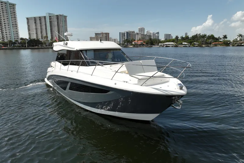 Slide: The Image of 2022 Regal 42 XO yacht cruising near city skyline on a sunny day. - 10