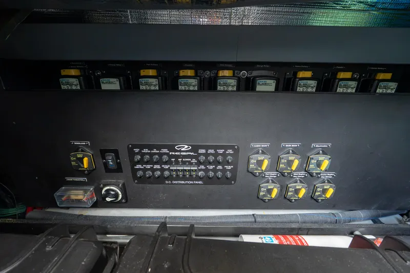 Slide: The Image of Electrical distribution panel of 2022 Regal 42 XO boat, featuring various switches and controls. - 63