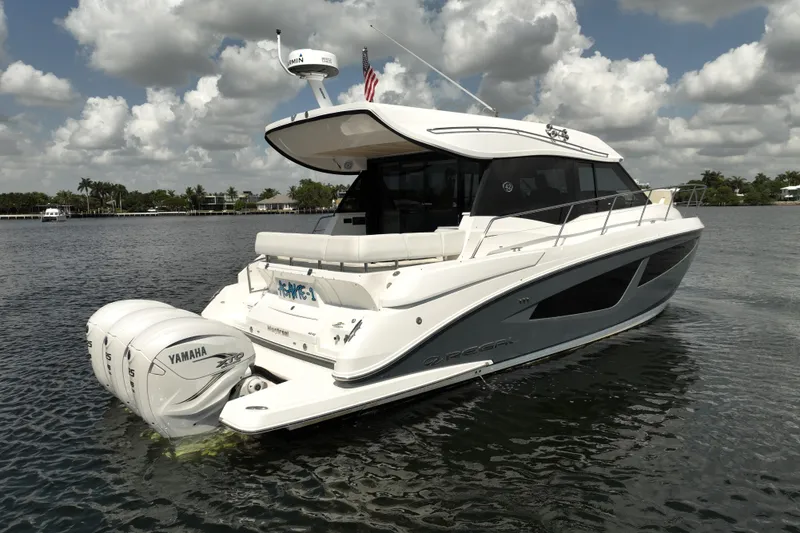 Slide: The Image of 2022 Regal 42 XO yacht on water, featuring Yamaha engines, under a partly cloudy sky. - 8