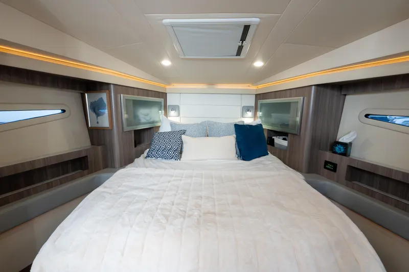 Slide: The Image of Luxurious cabin interior of 2022 Regal 42 XO yacht with cozy bedding and modern decor. - 47