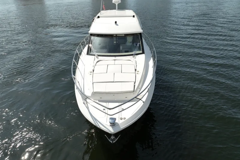 Slide: The Image of 2022 Regal 42 XO yacht on calm water, aerial view. - 11