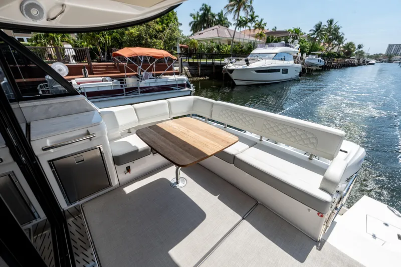 Slide: The Image of Luxurious 2022 Regal 42 XO yacht with elegant seating and waterfront view. - 23