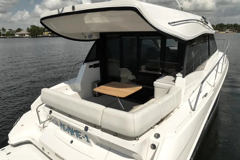 Slide: The Image of 2022 Regal 42 XO yacht with sleek design, spacious deck, and luxurious seating. - 5