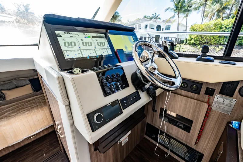 Slide: The Image of Helm of 2022 Regal 42 XO yacht with modern navigation displays and controls. - 40