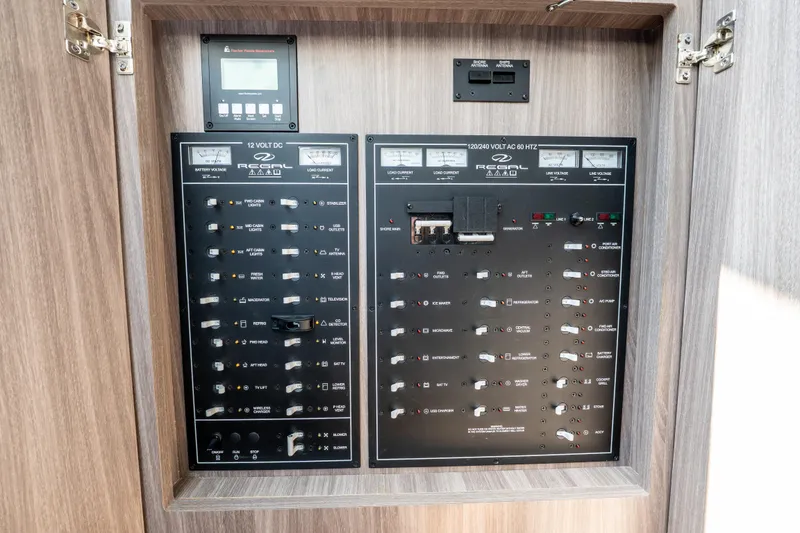 Slide: The Image of Electrical control panel of 2022 Regal 42 XO yacht, featuring switches and meters. - 45