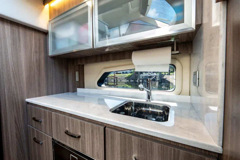 Slide: The Image of Modern kitchen interior of 2022 Regal 42 XO yacht with sleek cabinetry and stainless steel sink. - 57