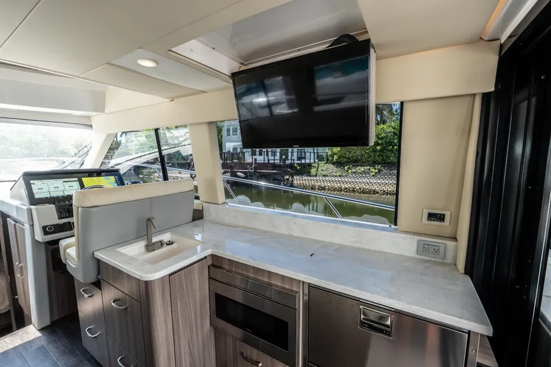 Slide: The Image of Luxurious interior of 2022 Regal 42 XO yacht with modern kitchen and navigation area. - 36