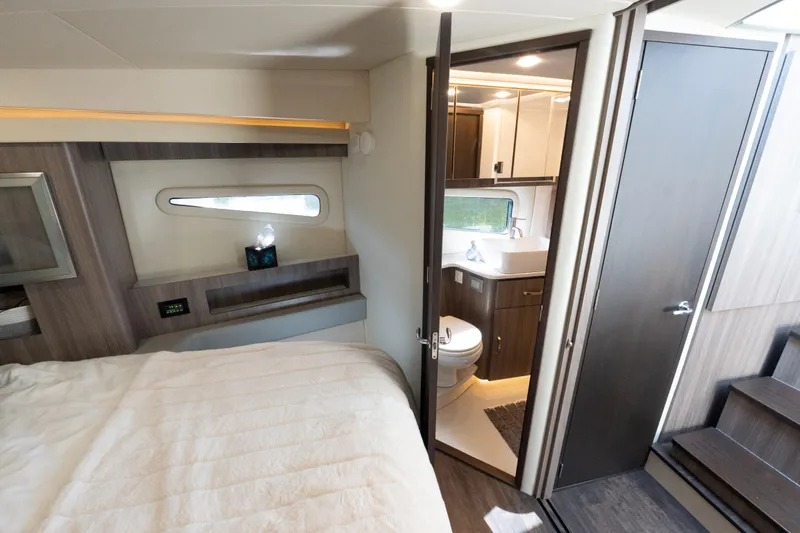 Slide: The Image of Luxurious interior of 2022 Regal 42 XO yacht featuring bedroom and bathroom. - 49