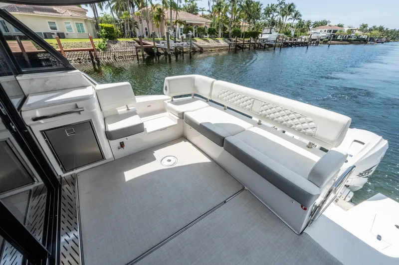 Slide: The Image of Luxurious seating area on 2022 Regal 42 XO yacht, docked by waterfront homes. - 21