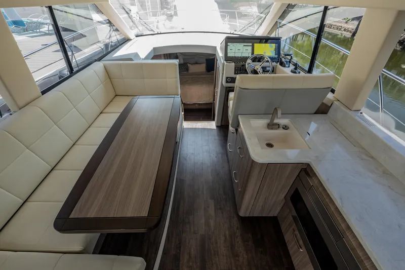 Slide: The Image of Luxurious interior of 2022 Regal 42 XO yacht with seating, helm, and kitchenette. - 30