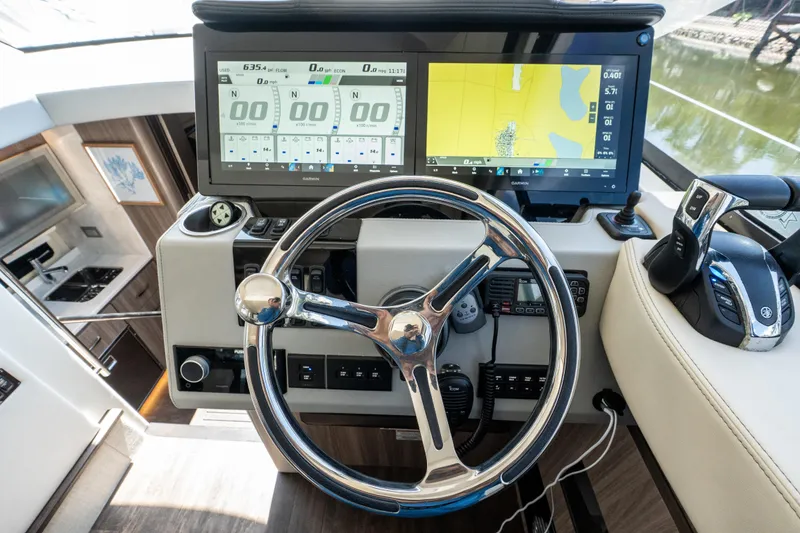 Slide: The Image of Helm of 2022 Regal 42 XO yacht with advanced navigation display and controls. - 43
