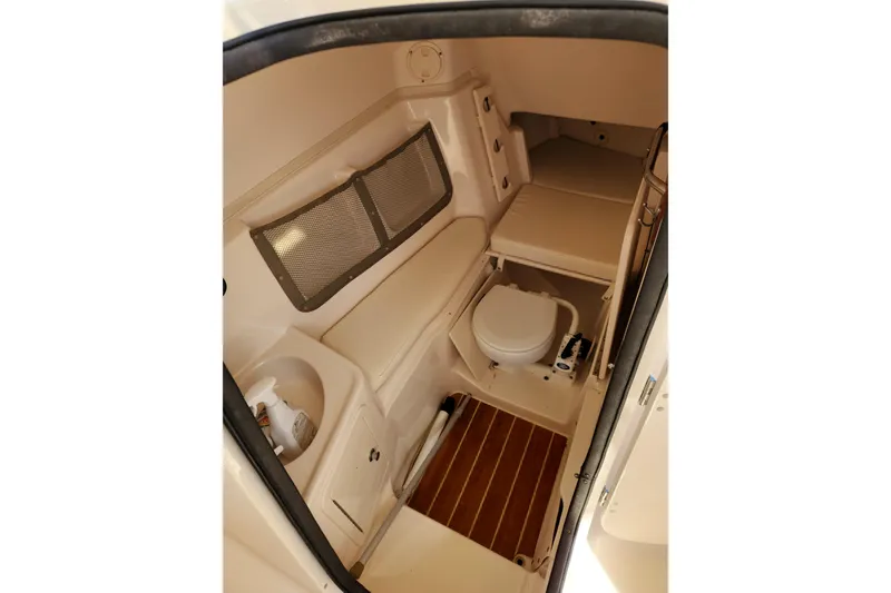 Slide: The Image of 2015 Grady-White Freedom 307 boat interior with toilet and seating area. - 18