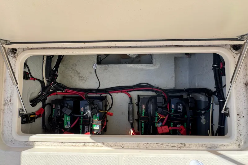 Slide: The Image of Battery compartment of a 2015 Grady-White Freedom 307 boat, showing wiring and connections. - 28