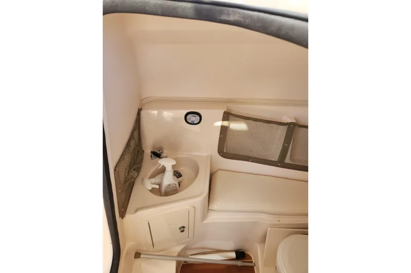 Slide: The Image of Interior of 2015 Grady-White Freedom 307 boat, featuring a compact bathroom area. - 19