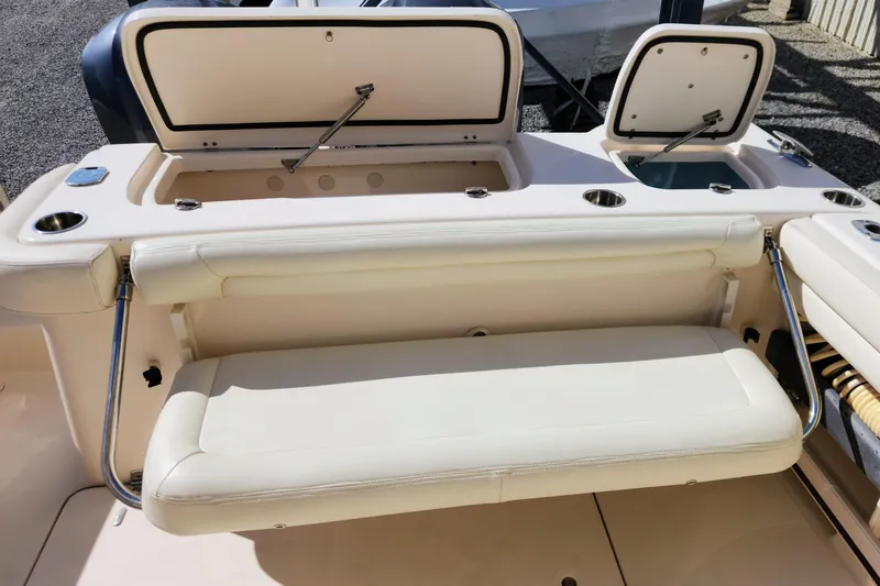 Slide: The Image of 2015 Grady-White Freedom 307 boat interior with seating and storage compartments. - 20