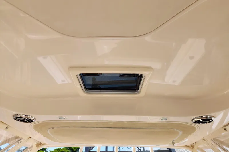 Slide: The Image of 2015 Grady-White Freedom 307 boat interior ceiling with hatch and speakers. - 16