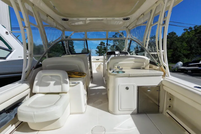 Slide: The Image of 2015 Grady-White Freedom 307 boat interior with seating and helm station. - 15