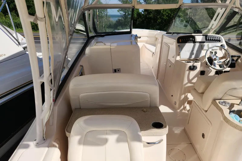 Slide: The Image of Interior of a 2015 Grady-White Freedom 307 boat, featuring luxurious seating and helm controls. - 13