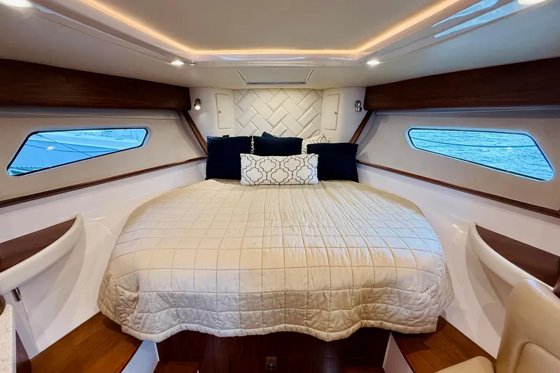 Slide: The Image of Luxurious cabin interior of 2021 Intrepid 410 Evolution yacht with cozy bedding. - 41
