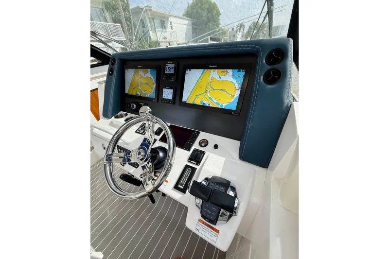 Slide: The Image of 2021 Intrepid 410 Evolution helm with dual navigation screens and modern steering wheel. - 31