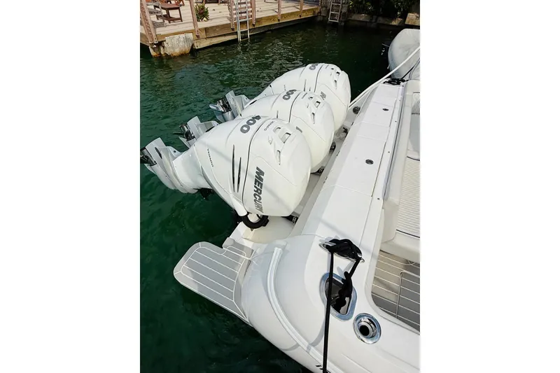 Slide: The Image of 2021 Intrepid 410 Evolution with triple Mercury outboard engines docked by the water. - 53