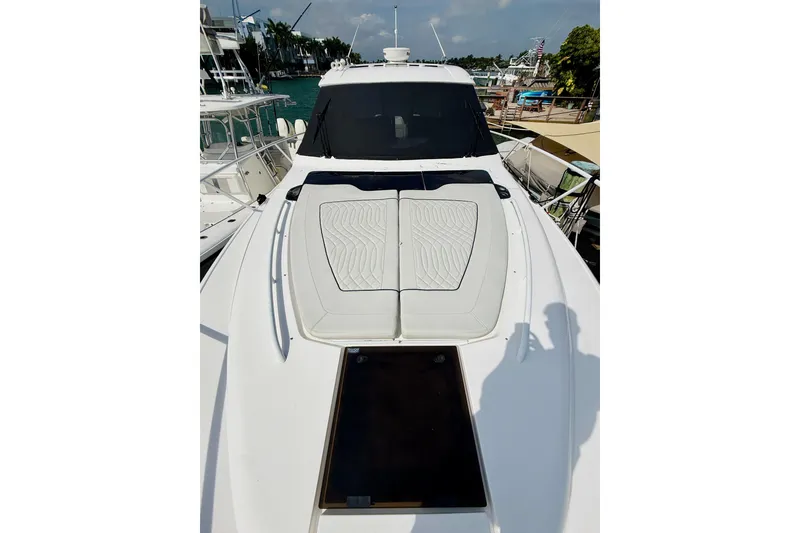 Slide: The Image of 2021 Intrepid 410 Evolution yacht with sleek deck design, docked at marina. - 6