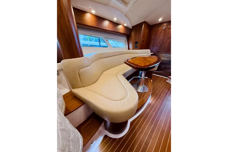 Slide: The Image of Luxurious interior of 2021 Intrepid 410 Evolution yacht with elegant seating and wooden accents. - 42