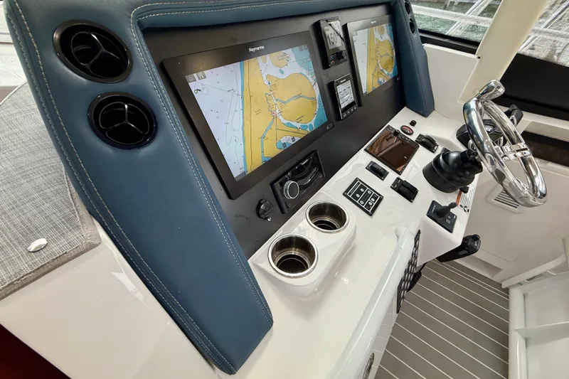 Slide: The Image of Intrepid 410 Evolution 2021 helm with navigation screens and controls. - 32