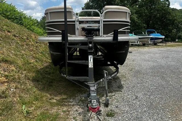 Slide: The Image of 2020 Sun Tracker SportFish 22 XP3 pontoon boat on trailer, parked on gravel. - 13