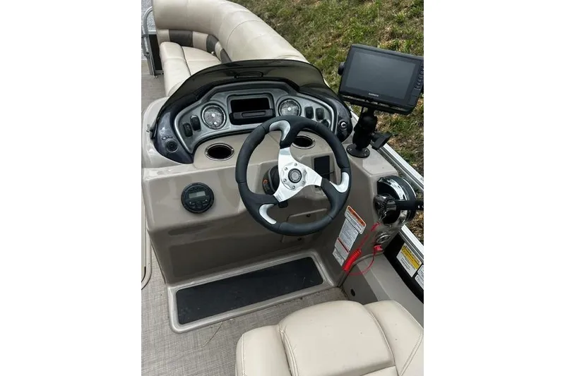 Slide: The Image of 2020 Sun Tracker SportFish 22 XP3 boat dashboard with steering wheel and navigation system. - 15
