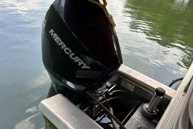 Slide: The Image of Mercury outboard motor on 2020 Sun Tracker SportFish 22 XP3, docked on calm water. - 3