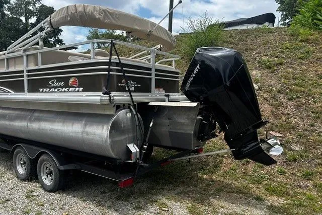 The Image of 2020 Sun Tracker SportFish 22 XP3 pontoon boat with Mercury outboard motor on trailer. - 0