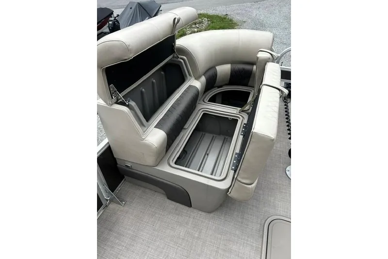 Slide: The Image of 2020 Sun Tracker SportFish 22 XP3 boat with open storage compartments and cushioned seating. - 6
